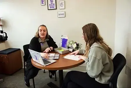Elizabeth Schwanke (left) advising a student (right).