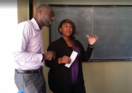 Providing professional development for teachers in Zambia by modeling lessons for them.