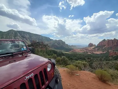 The journey up Schnebly Hill Road in Sedona is a masterclass in the idea that the most meaningful progress often happens on the most rugged paths. Navigating this historic eleven-mile wagon trail requires a steady hand and the resilience to endure a bumpy, moderate climb through the signature red rocks of the Coconino National Forest. As the trail gains 1,800 feet in elevation, the route narrows into steep passes that demand focus and a willingness to embrace the journey as much as the destination. Whether you are leading a team in a laboratory, managing a hectic household, or breaking barriers in a boardroom, the ability to remain composed while navigating narrow, uncertain terrain is what defines true influence. This climb serves as a tribute to my late dog, Odin, who was my constant partner through every rugged mile and scenic overlook, teaching me that the challenges are always secondary to the beauty of the company you keep. Transitioning from the broken rock to the red dirt with a great friend by my side reminds me that influence happens wherever you have the grit to keep steering forward toward a higher perspective. Looking out over the crimson spires of Oak Creek Canyon under a perfect, clear sky, I realized this is still one of the best office views I have ever had.
