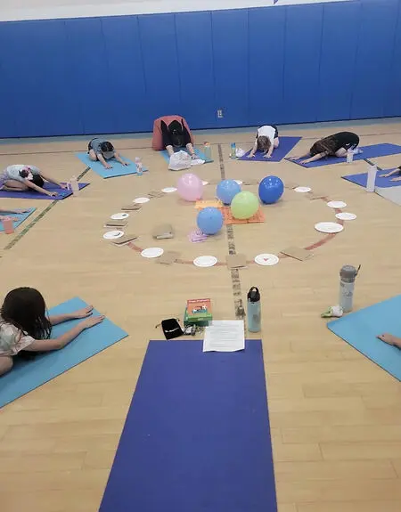 Leading an after school yoga club for 2nd and 3rd grade students. 