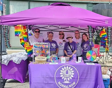 This photo marks a beginning.
July 2025 was Normal NOW’s first event as an organized group. Together, we showed up for Pride, showed support, and affirmed our commitment to being an engaged and active part of our community. 