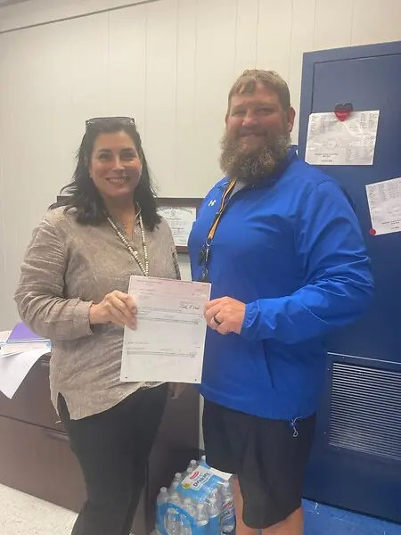 This is me presenting the $1,000 check on behalf of CommuniHealth Services (my employer) to sponsor a local school's athletics department. 