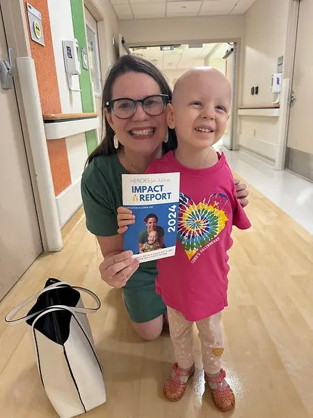Cancer patient, Annaliese, and I bonding over her cover photo of the 2024 Impact Report 