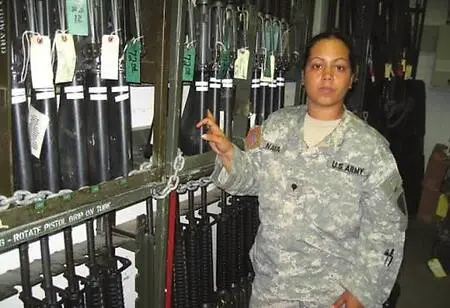 This photo was in my unit's arms room while on active duty, standing beside a neatly secured rack of rifles. The military setting is clear in the organized layout, the tagged weapons,  and my U.S. Army uniform. Taken during work for the *Lioness* film, it reflects both the discipline of the environment and the authenticity of your role.