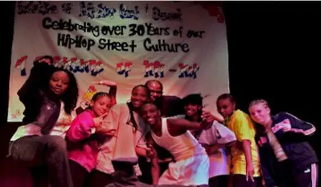 This photo was taken following one of my sold-out New York productions, *Hip Hop Past & Present*, at Jamaica Fine Arts. It captures a proud milestone shared with my cast after bringing a full-length celebration of hip-hop history and street culture to the stage.
