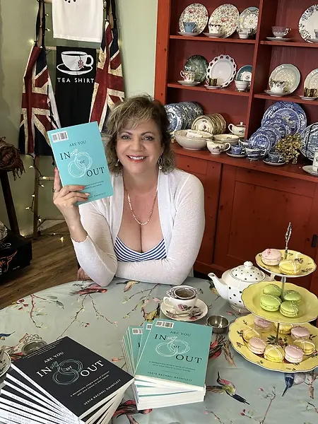 Vesta Rachael Gauntlett with her book, Are You In or Out?, which encourages couples to consciously choose the future of their relationship.