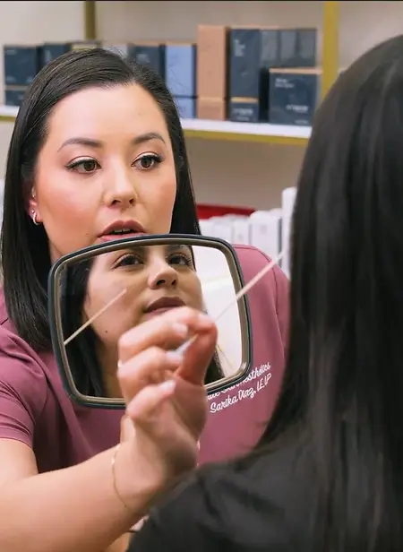 Sarika Diaz, Founder of True Skin Aesthetics performing a skin assessment during a consultation. 